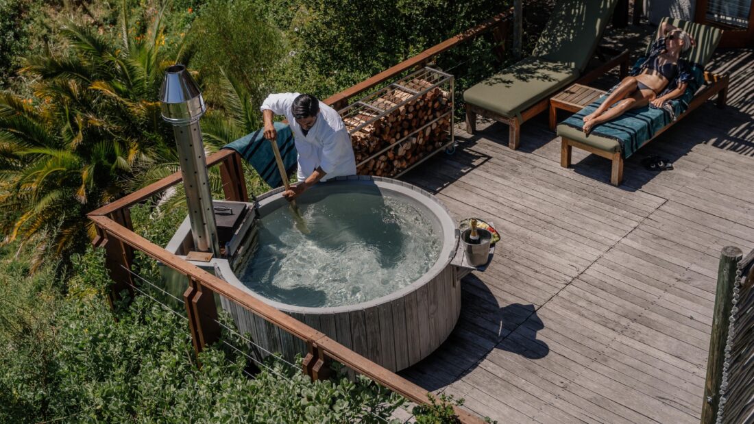 Wood fired hot tub in landscaped garden with natural materials