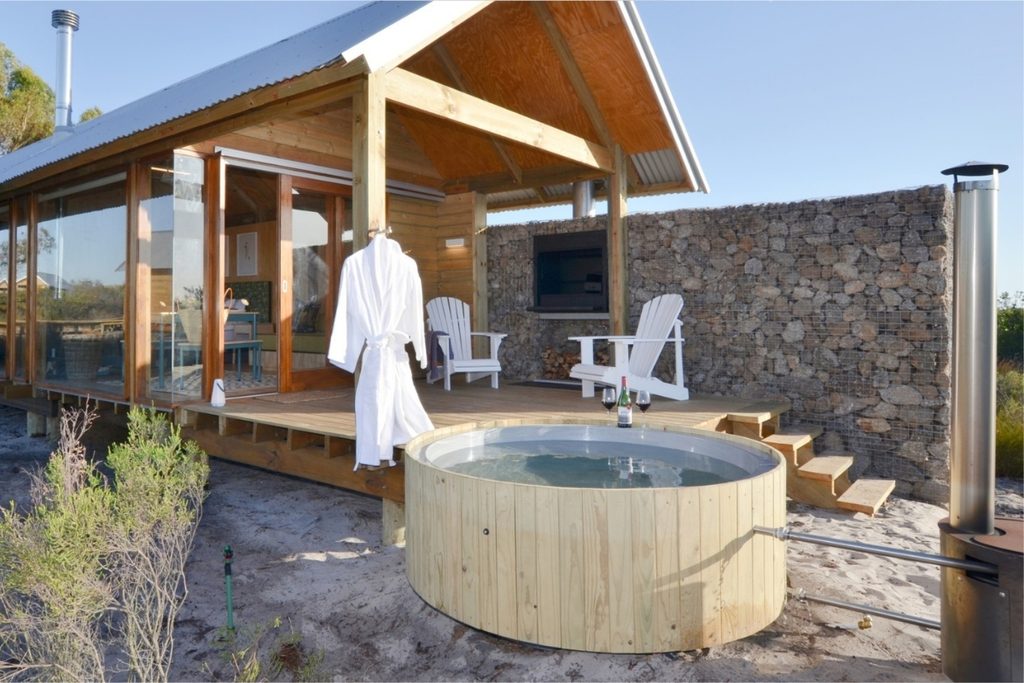 Buitengewoon wood-fired hot tub beside an eco cabin at !Khwa ttu Nature Reserve on the West Coast