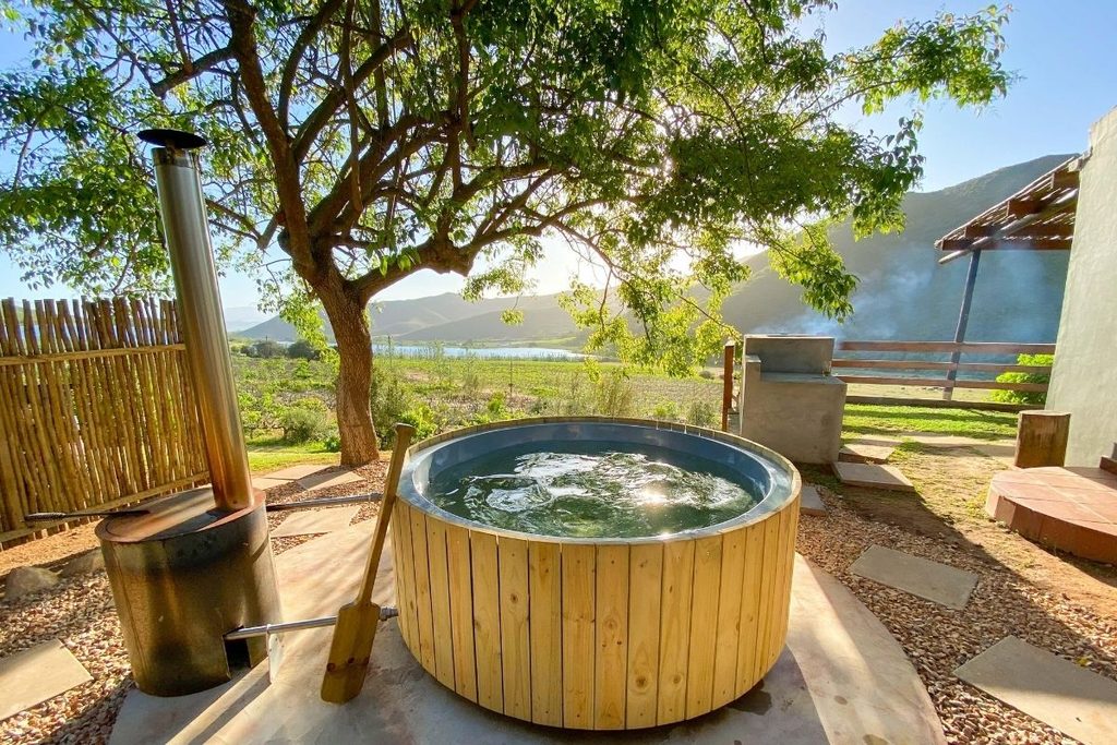 Buitengewoon wood-fired hot tub beneath a tree at Pat Busch Mountain Reserve near Robertson